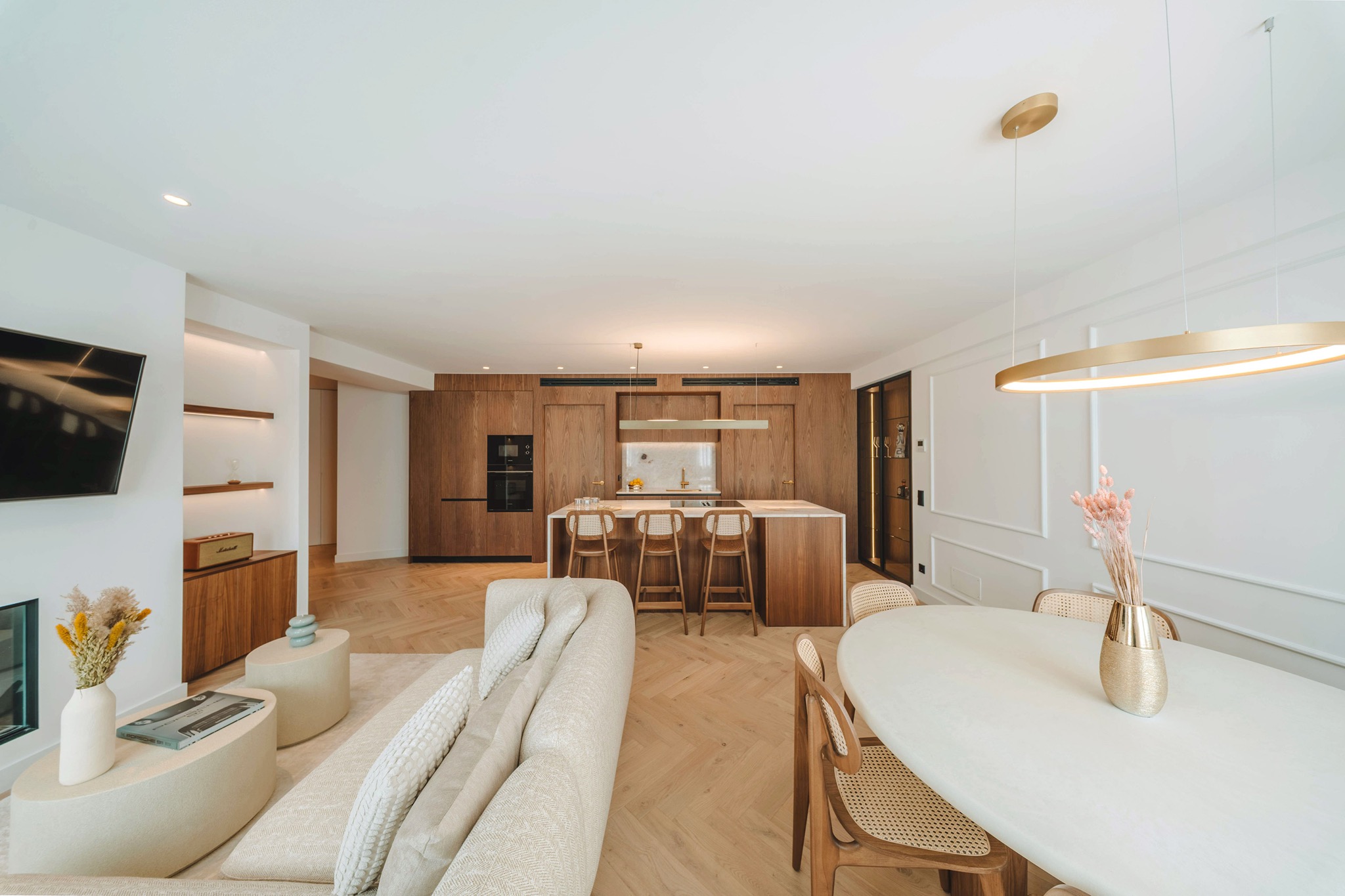 Living and dining area with walnut kitchen and herringbone oak floor