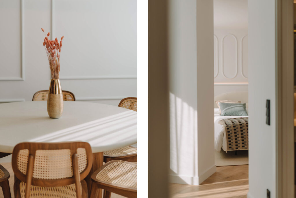 Dining table with rattan chairs and view of the bedroom in a turnkey home
