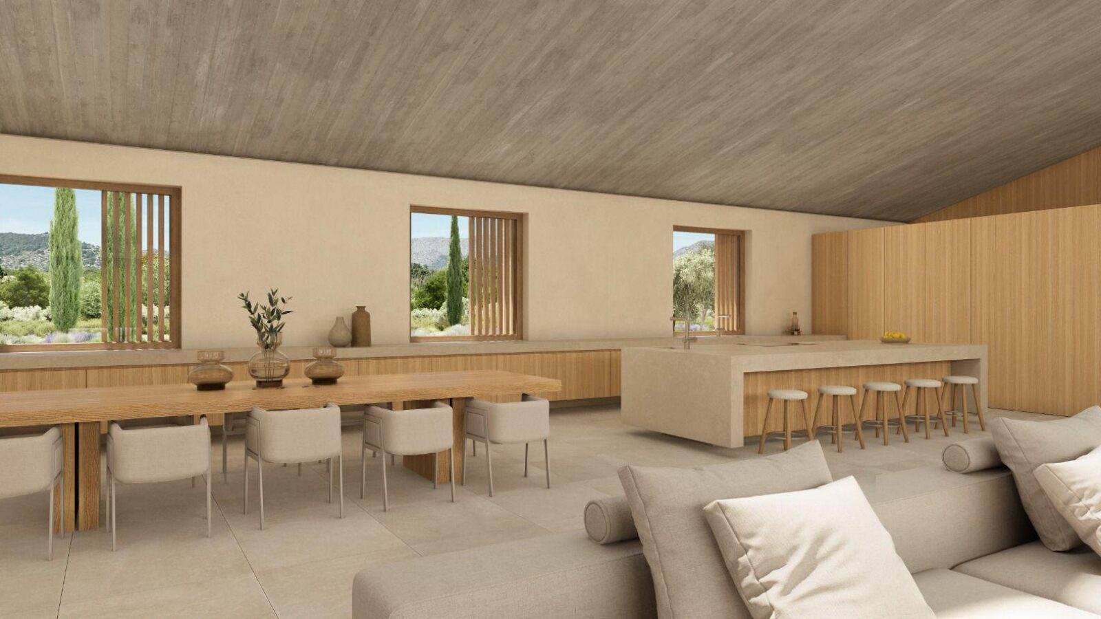Dining area with long table beside the kitchen and garden views