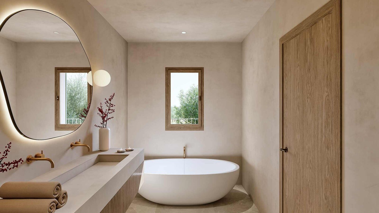 Bathroom with a white freestanding bathtub, wall-hung basin, illuminated mirror and garden views